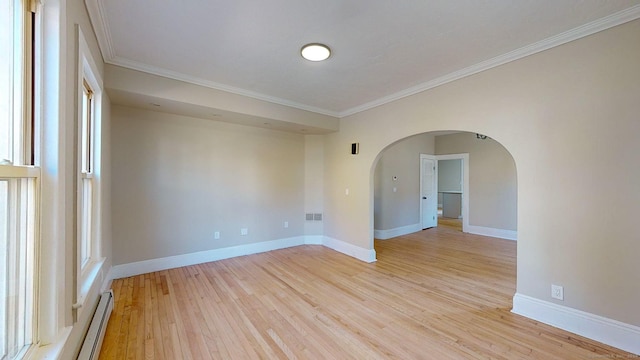 spare room with light hardwood / wood-style floors and crown molding