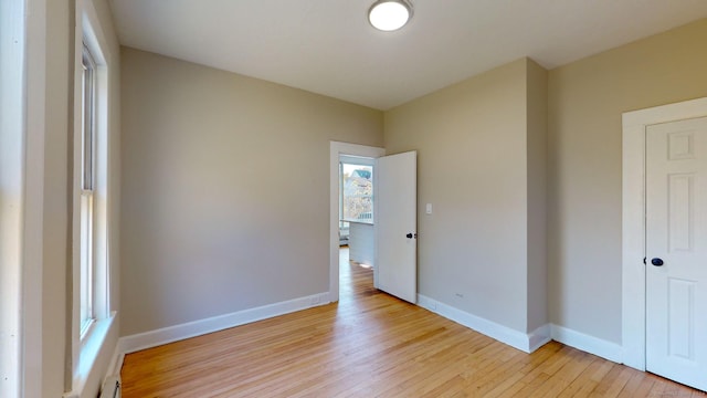 unfurnished bedroom featuring light hardwood / wood-style flooring and multiple windows