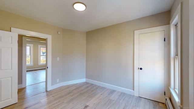 spare room with light hardwood / wood-style flooring and a baseboard heating unit