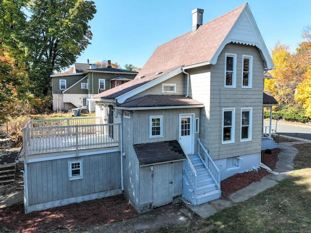 rear view of house with a wooden deck