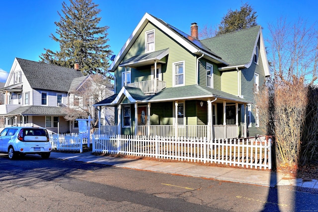 view of front of house with a porch and a balcony