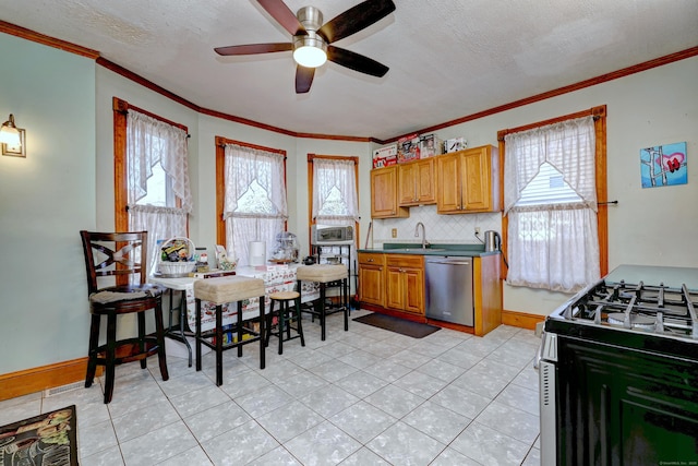 kitchen featuring sink, gas range, stainless steel dishwasher, ceiling fan, and decorative backsplash