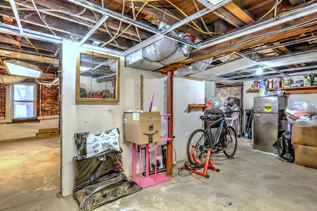 basement featuring stainless steel refrigerator