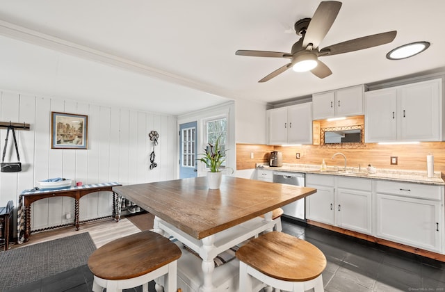 dining area with ceiling fan and sink