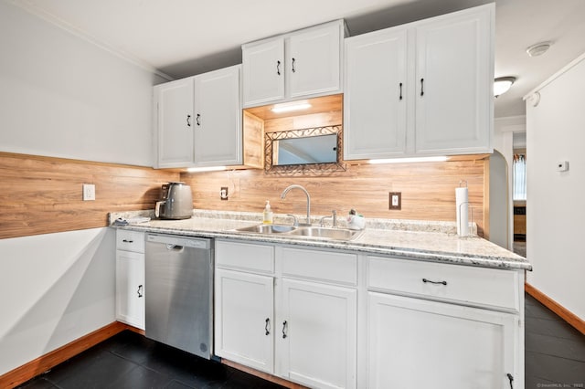 kitchen featuring tasteful backsplash, dishwasher, white cabinets, and sink