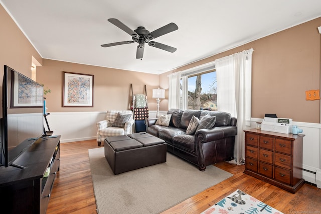 living room featuring hardwood / wood-style floors and ceiling fan