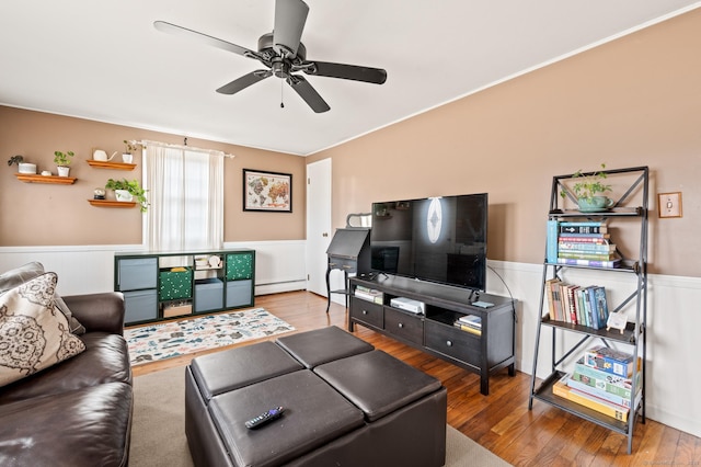 living room featuring hardwood / wood-style floors, ceiling fan, and a baseboard radiator