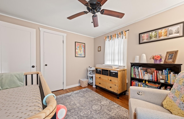 interior space featuring ceiling fan, hardwood / wood-style floors, and ornamental molding