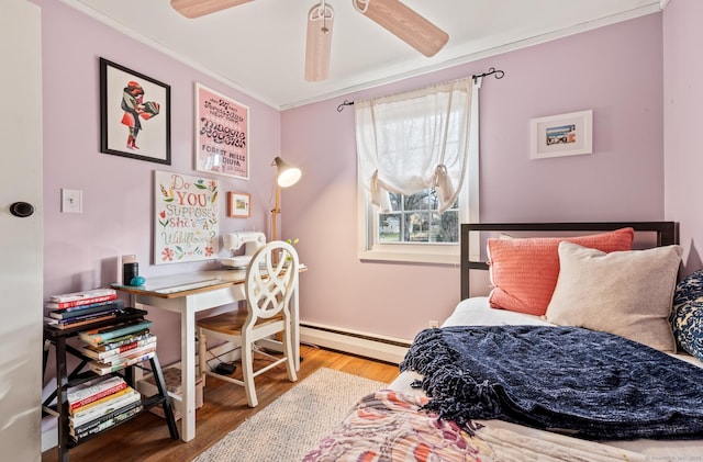 bedroom with hardwood / wood-style flooring, ceiling fan, ornamental molding, and baseboard heating