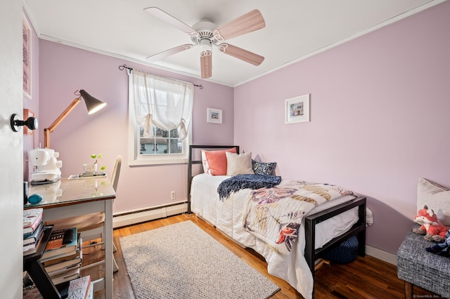 bedroom featuring wood-type flooring, a baseboard radiator, ceiling fan, and ornamental molding