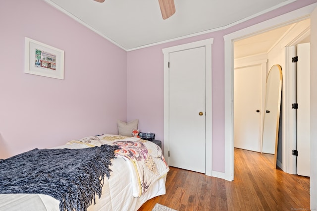 bedroom featuring hardwood / wood-style floors, ceiling fan, and crown molding