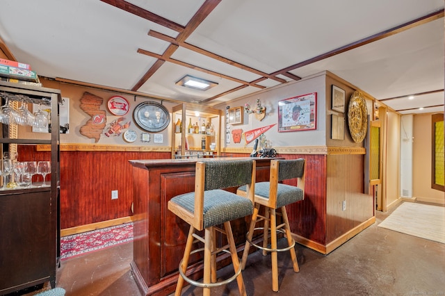 bar with wood walls and coffered ceiling