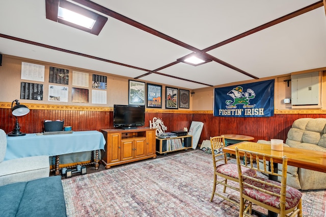 living room with wood walls and electric panel