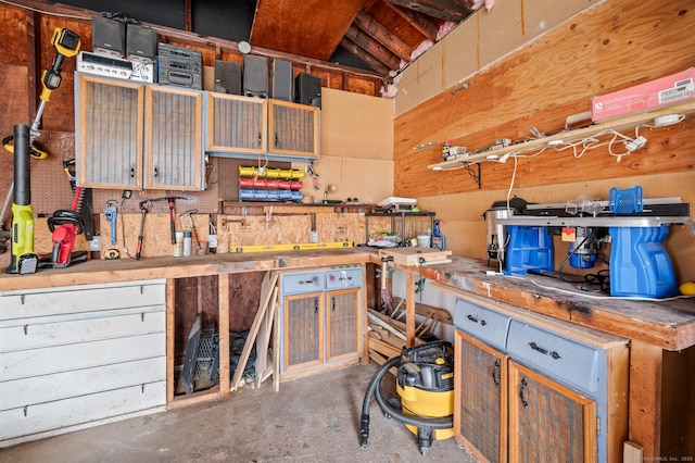 misc room with a workshop area and concrete floors