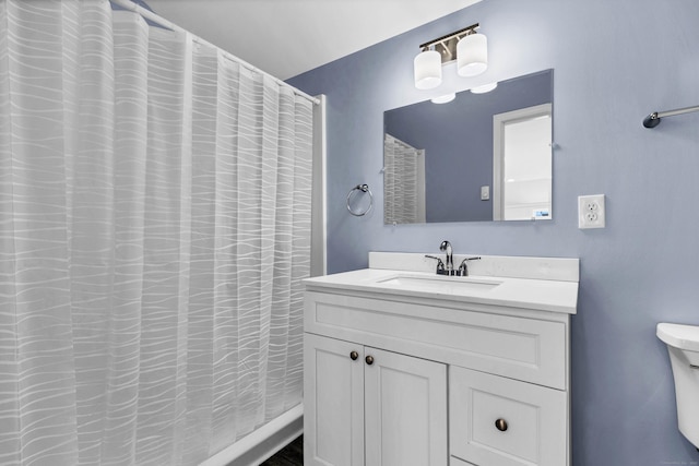 bathroom featuring vanity and a shower