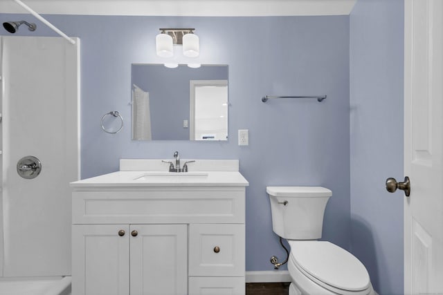 bathroom with a shower, vanity, and toilet