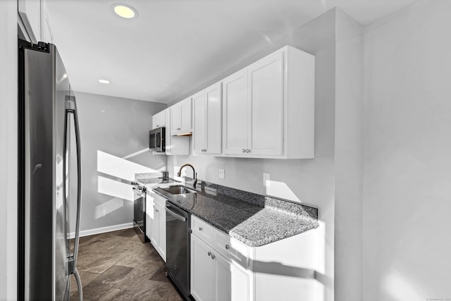 kitchen with white cabinetry, dark stone counters, and appliances with stainless steel finishes