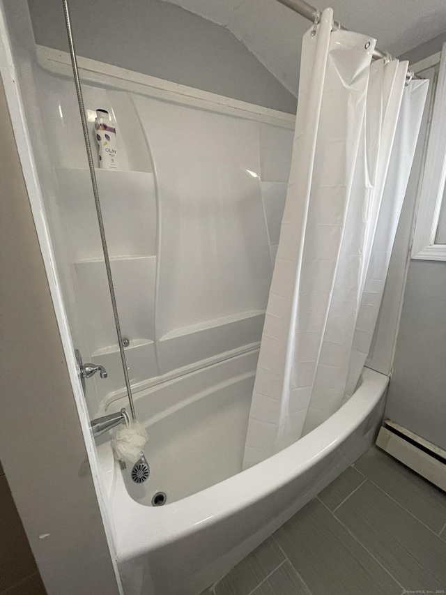 bathroom with tile patterned flooring, shower / bath combination with curtain, lofted ceiling, and a baseboard radiator