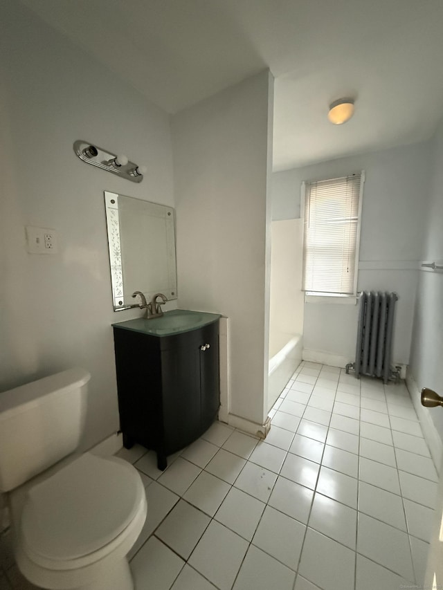 bathroom featuring radiator heating unit, vanity, toilet, and tile patterned floors