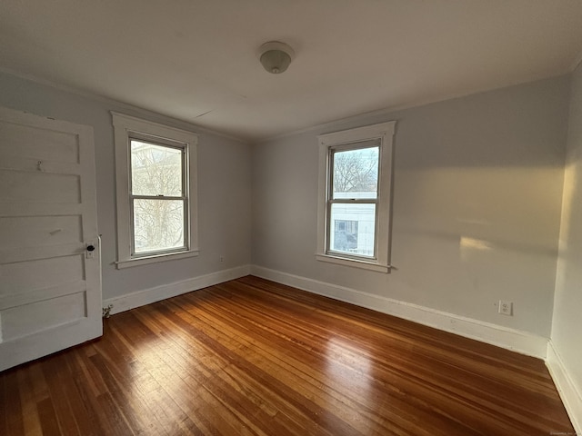 spare room with dark hardwood / wood-style floors