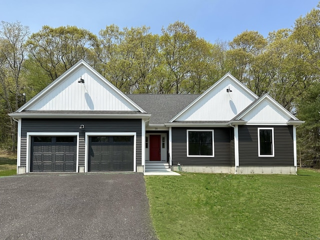 view of front of house with a garage and a front lawn