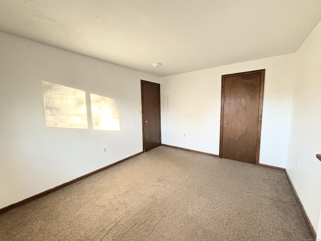 unfurnished bedroom featuring carpet flooring, a textured ceiling, and a closet