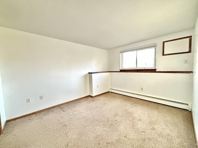 carpeted spare room with baseboard heating