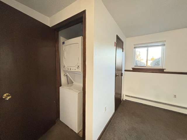 clothes washing area featuring baseboard heating, stacked washer and dryer, a textured ceiling, and dark colored carpet