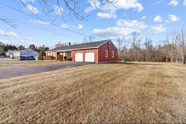 exterior space with a yard and a garage