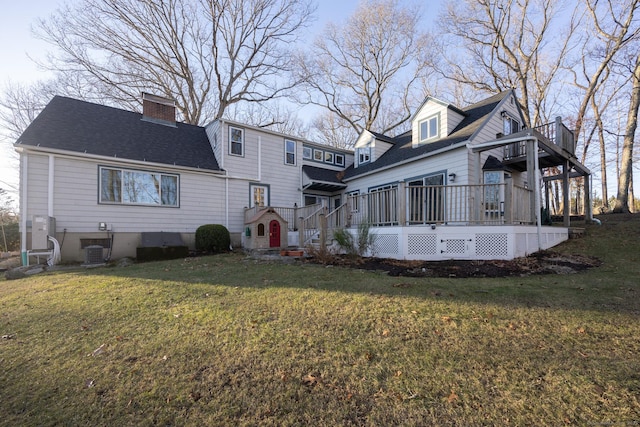 back of house featuring central air condition unit, a wooden deck, and a yard