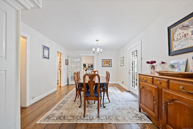 dining room featuring a chandelier and light wood-type flooring