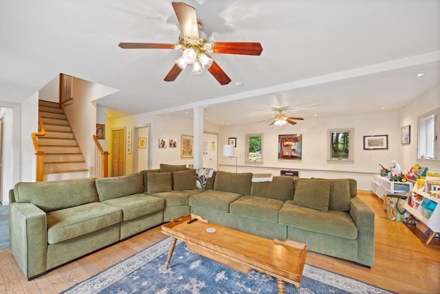 living room with ceiling fan and light wood-type flooring