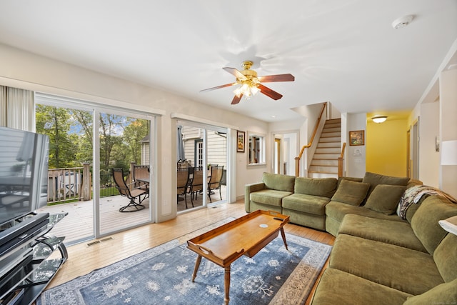 living room featuring hardwood / wood-style flooring and ceiling fan