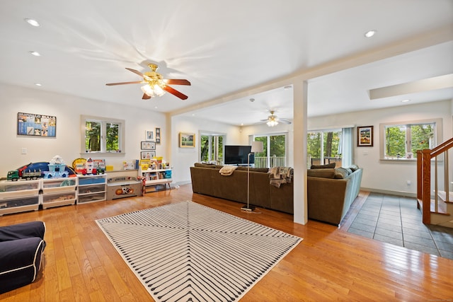 living room with ceiling fan and light wood-type flooring