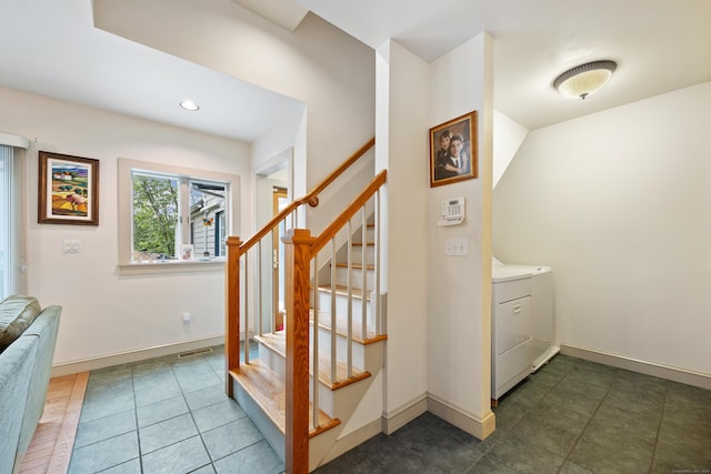 staircase with washer and clothes dryer