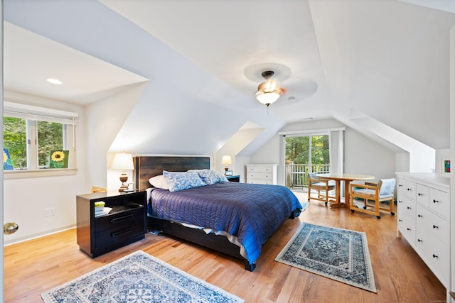 bedroom with ceiling fan, light wood-type flooring, and lofted ceiling