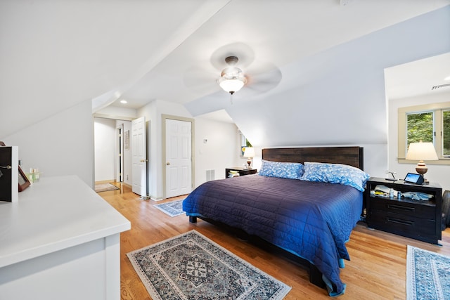 bedroom with hardwood / wood-style floors, ceiling fan, and vaulted ceiling