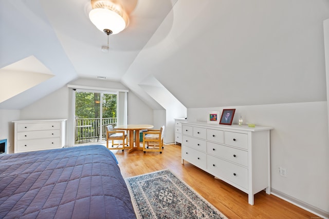 bedroom featuring access to exterior, vaulted ceiling, and light wood-type flooring