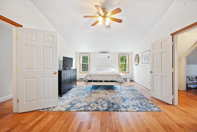 bedroom with ceiling fan, light wood-type flooring, vaulted ceiling, and a baseboard heating unit