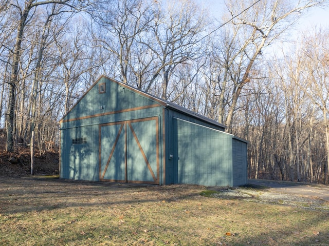 view of outbuilding featuring a lawn