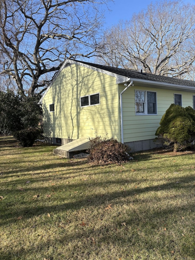 view of side of home with a yard