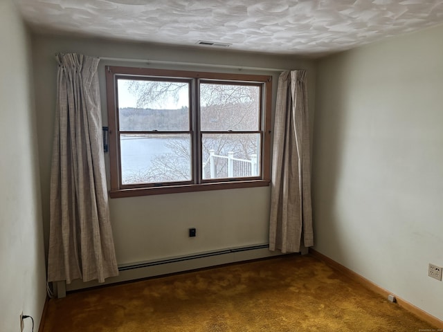 spare room featuring carpet, a textured ceiling, and a baseboard radiator