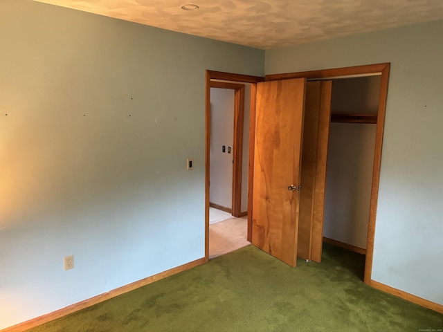 unfurnished bedroom featuring a closet and carpet floors