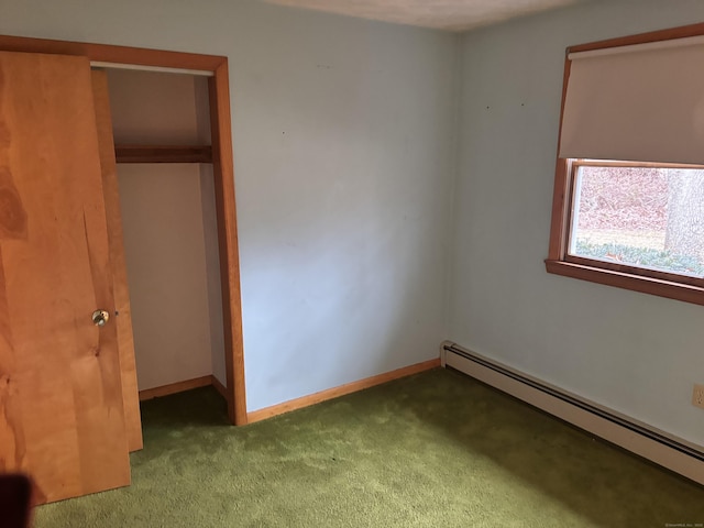 unfurnished bedroom featuring carpet floors, a baseboard radiator, and a closet