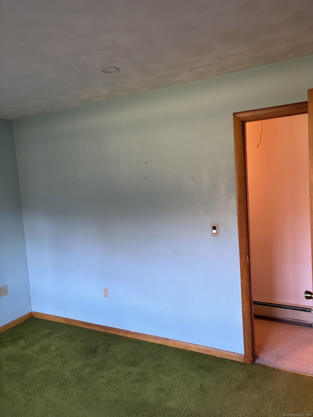 spare room featuring carpet flooring and baseboard heating