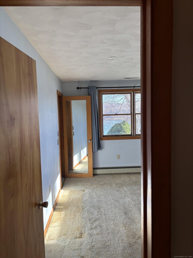 145 Massapeag Side Rd, Montville, CT 06382 - corridor featuring a baseboard heating unit, carpet, and baseboards