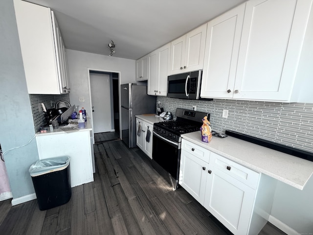 kitchen featuring white cabinets, decorative backsplash, and stainless steel appliances