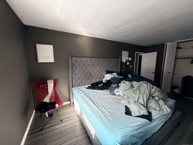 bedroom featuring hardwood / wood-style flooring and a closet