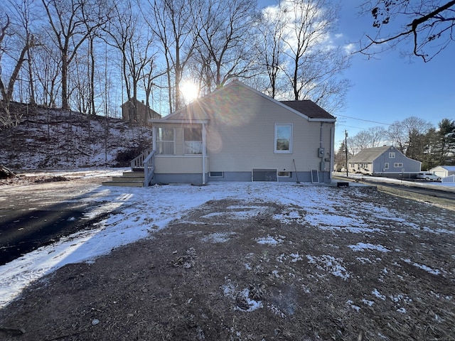 view of snow covered rear of property