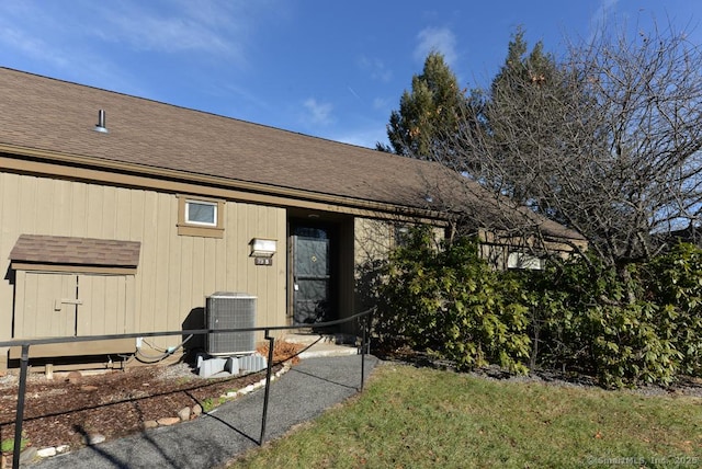 rear view of property featuring central AC